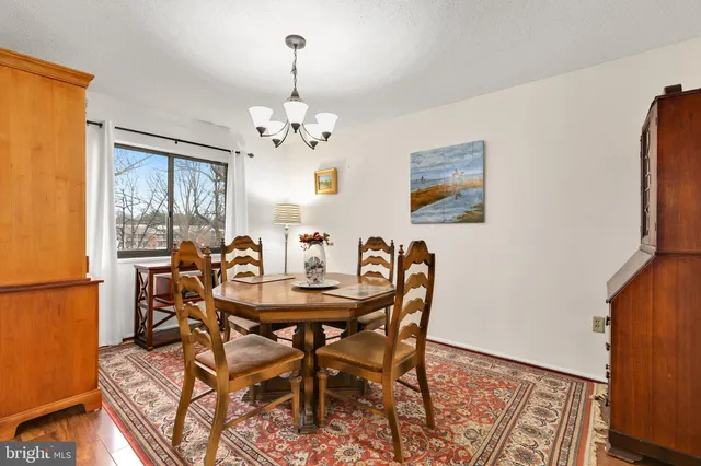 a view of a dining room with furniture and chandelier