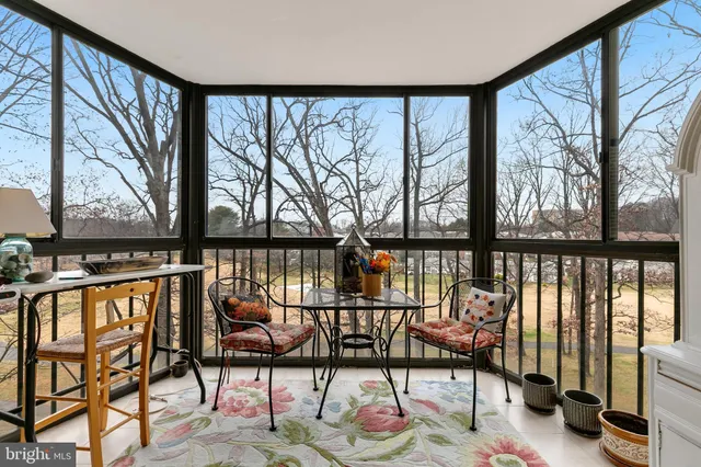 a balcony with furniture and a potted plant