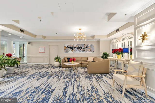 a living room with furniture and a chandelier