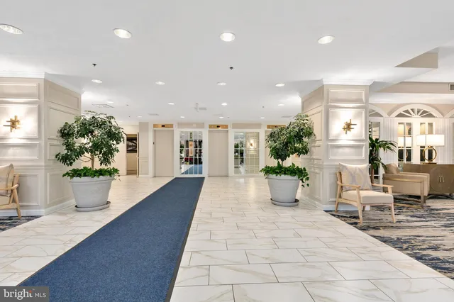 a living room with stainless steel appliances kitchen island granite countertop furniture and a fireplace