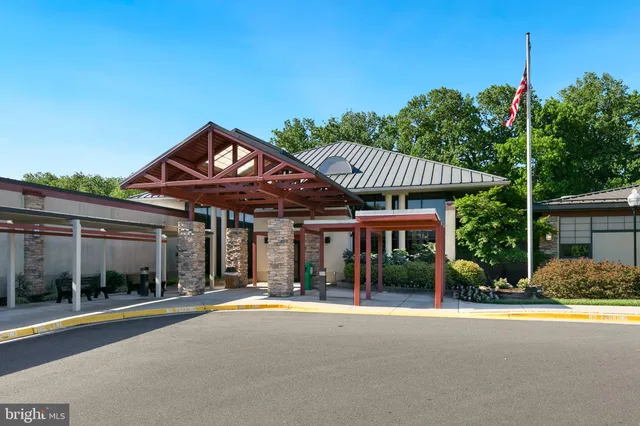 a living room with fireplace furniture and a large window