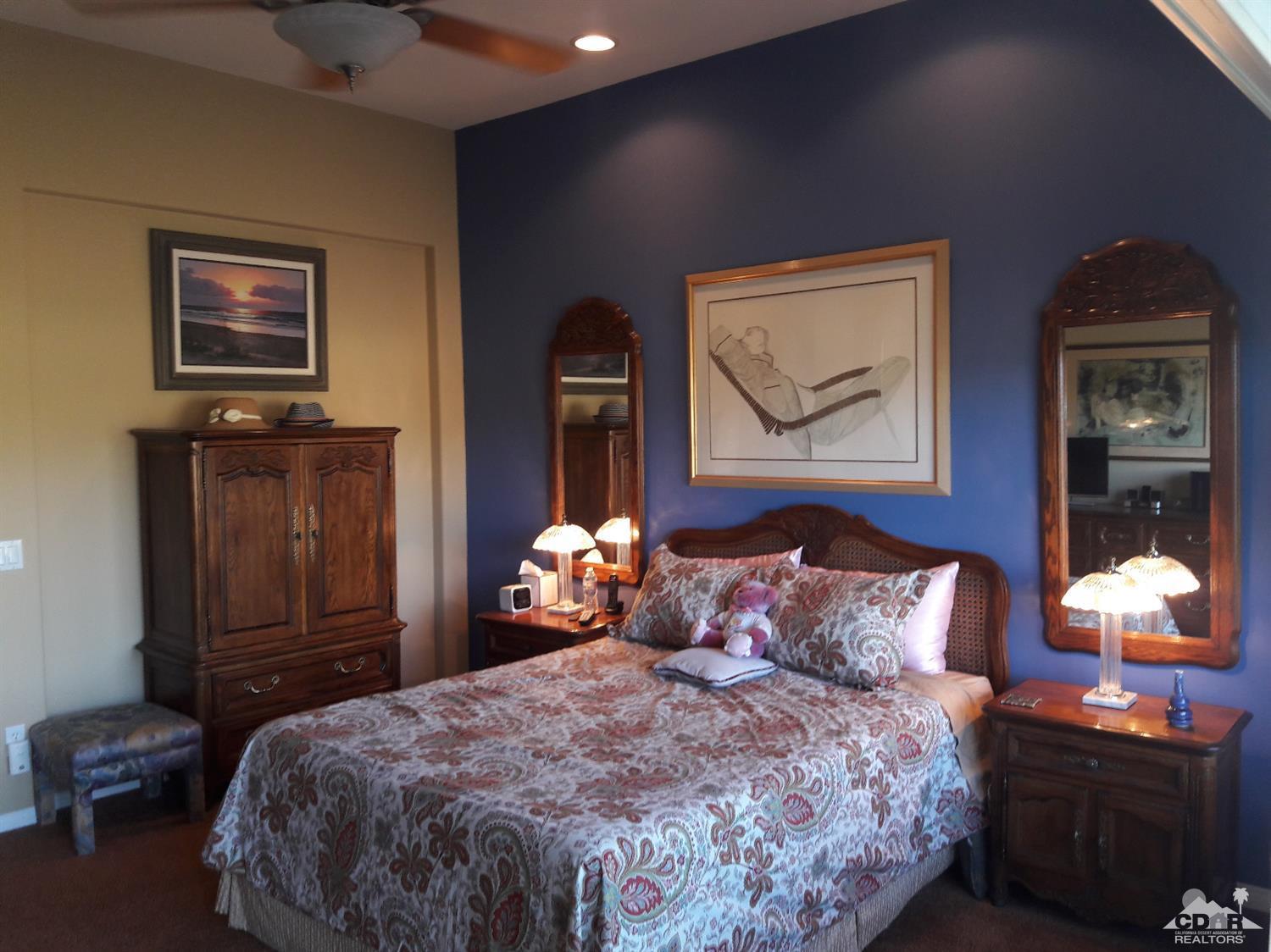 80546 Knightswood Road Indio, CA 92201 - Photo 14 of 35 a bedroom with a bed and a lamp on dresser