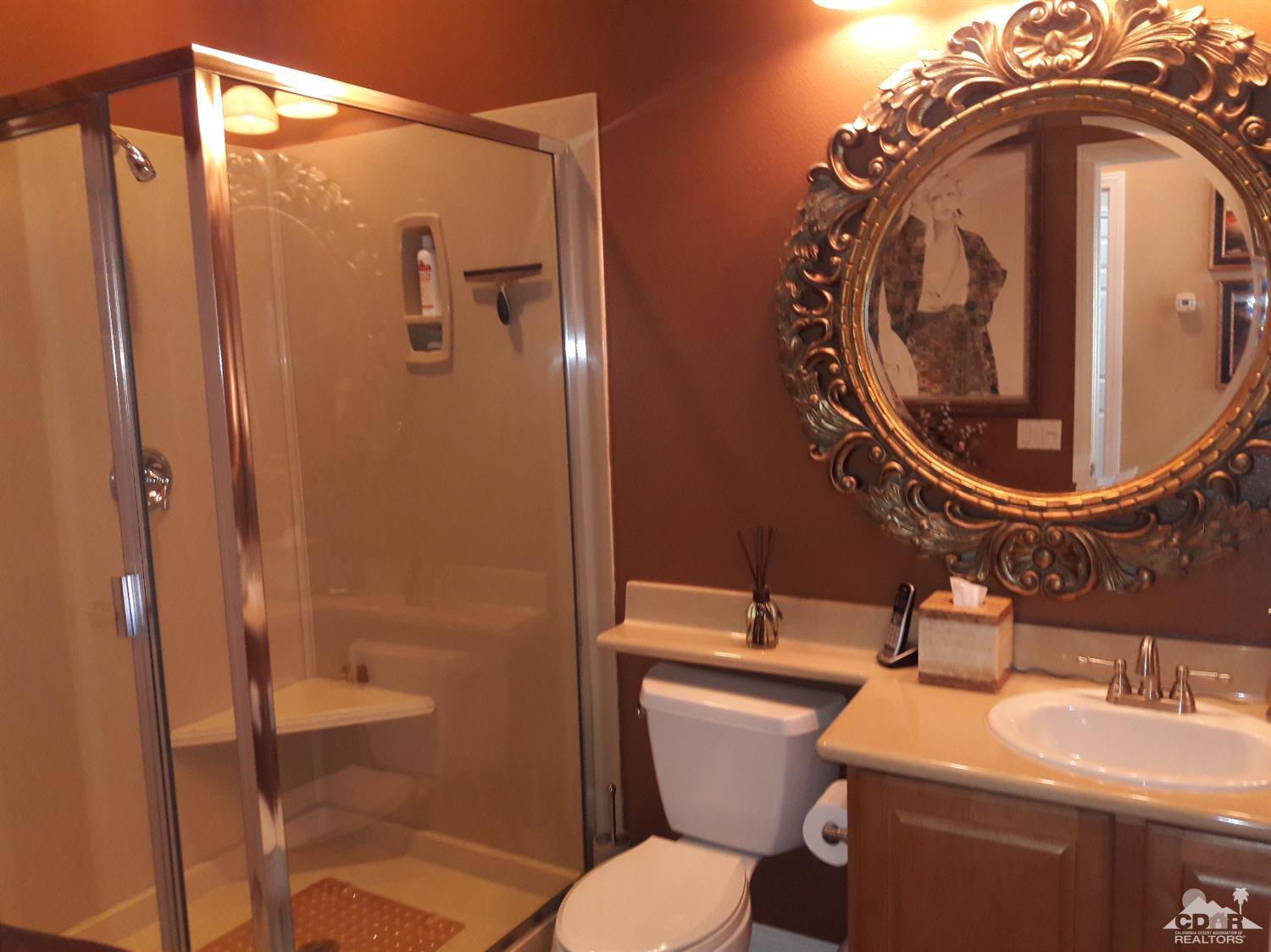 80546 Knightswood Road Indio, CA 92201 - Photo 22 of 35 a bathroom with a sink a toilet and a mirror