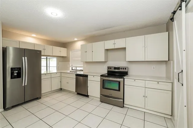 a kitchen with a stove top oven sink and cabinets