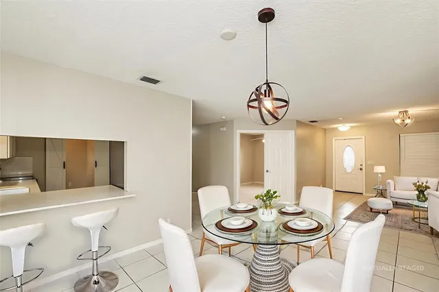 a dining room with furniture and window