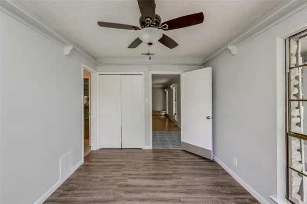 a view of empty room with wooden floor