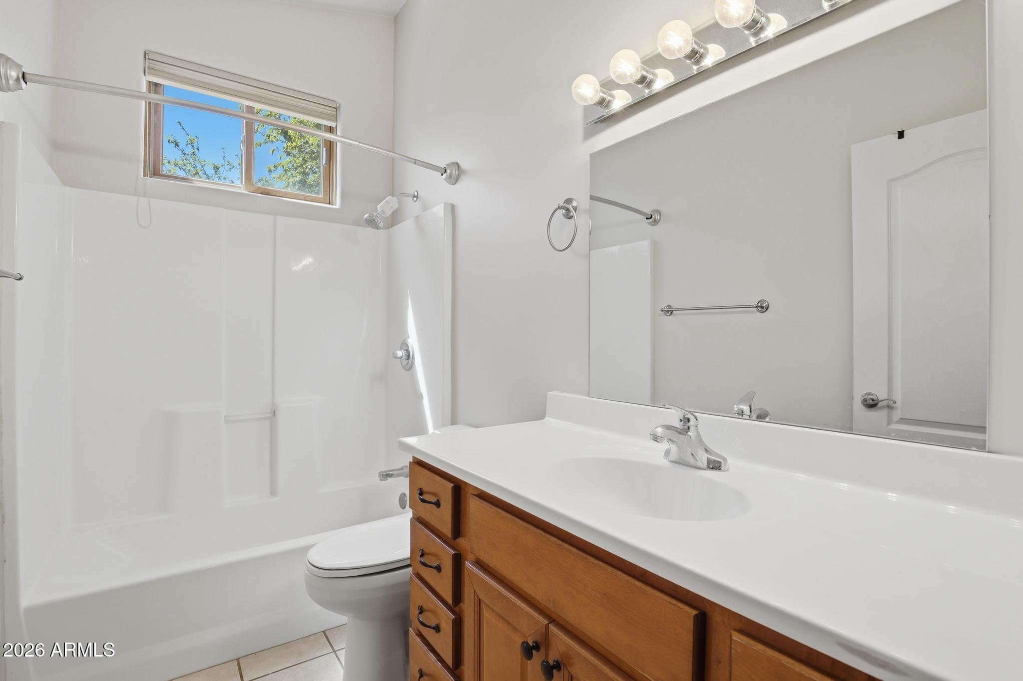 408 East Phoenix Street Payson, AZ 85541 - Photo 16 of 35 a bathroom with a sink a toilet a mirror and shower