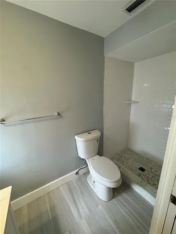a white toilet sitting next to a bathroom sink