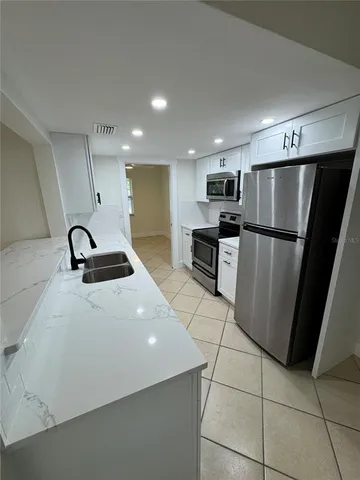 a kitchen with stainless steel appliances a refrigerator and a sink
