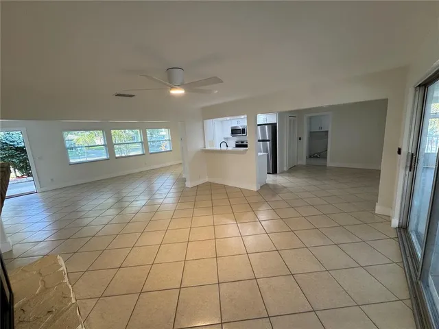 a view of a kitchen with furniture and an empty room