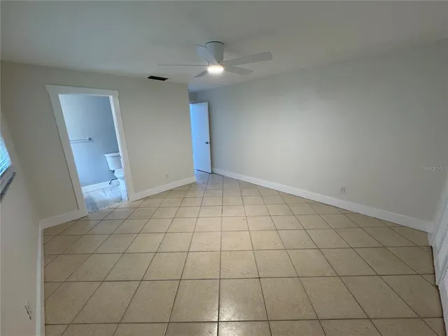 an empty room with white walls and tiles