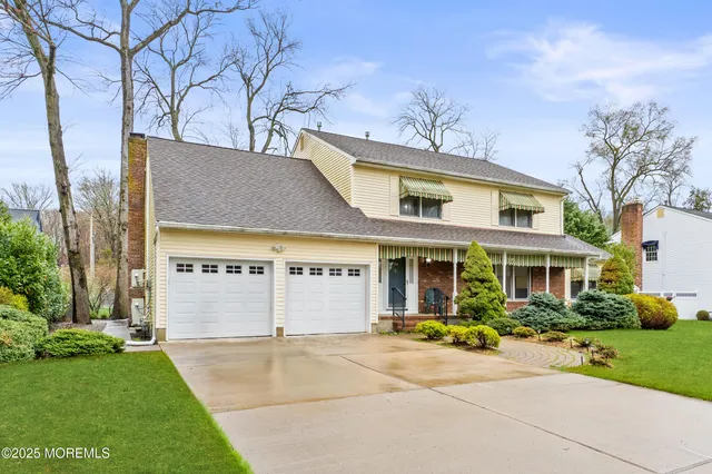 a view of a white house with a yard patio and fire pit