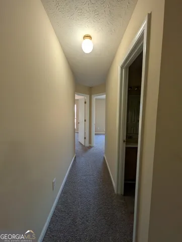 a view of hallway with livingroom