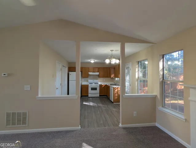 a view of living room filled with furniture and large window