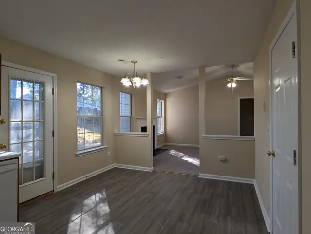 a view of a big room with windows and wooden floor