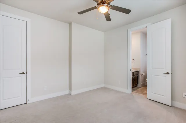 a bathroom with a granite countertop toilet sink and mirror