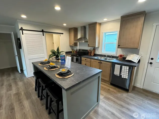 a kitchen with sink stove and refrigerator