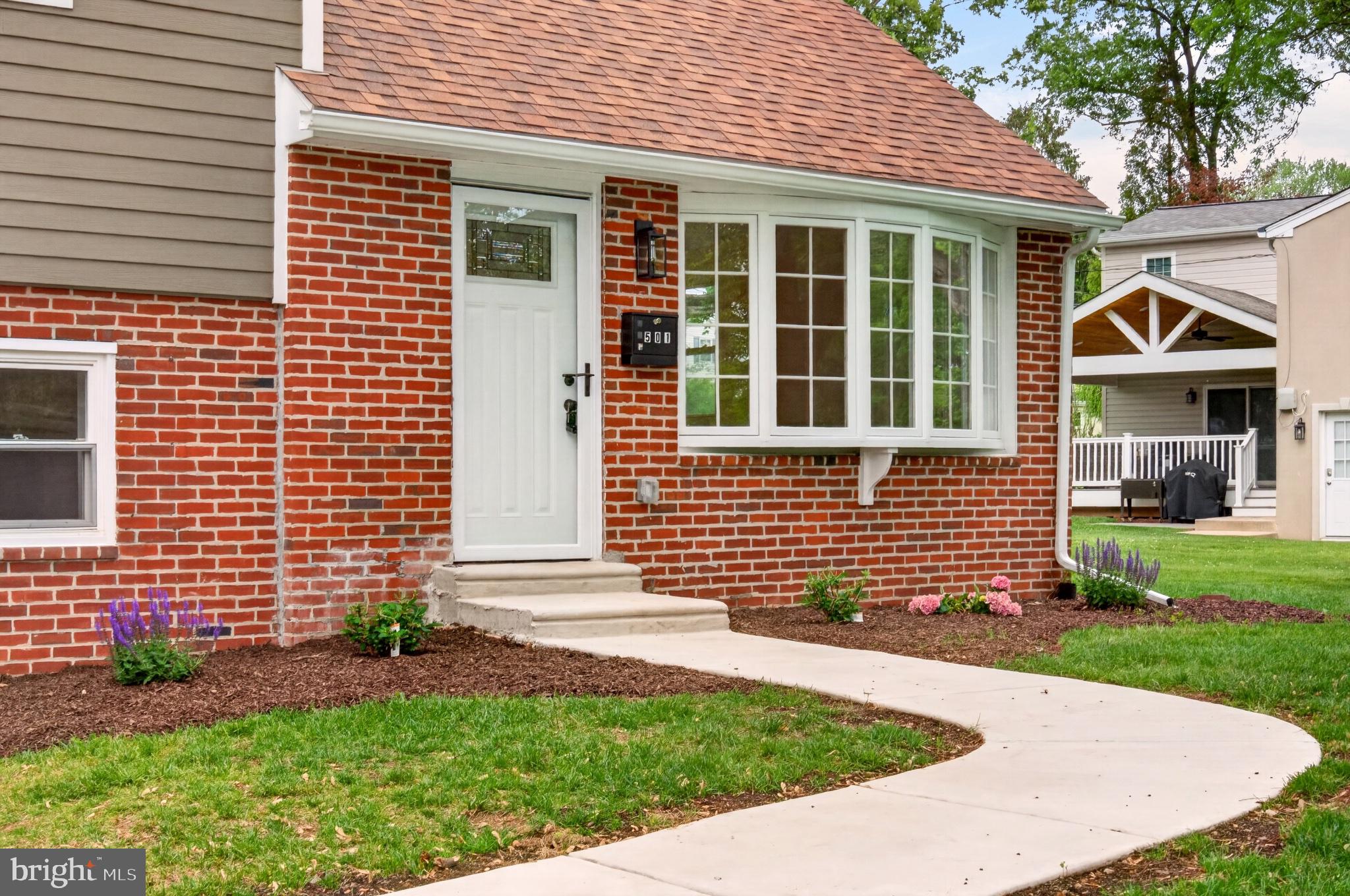 501 Hemlock Road Flourtown, PA 19031 - Photo 47 of 47 Charming brick facade with lush greenery.