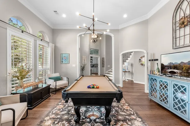 a living room with furniture and a chandelier