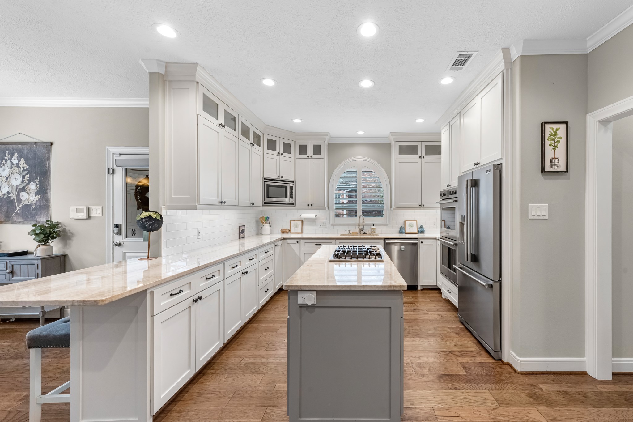 16207 Lafone Drive Spring, TX 77379 - Photo 17 of 49 a large kitchen with stainless steel appliances kitchen island a large counter top a stove a sink a refrigerator and cabinets