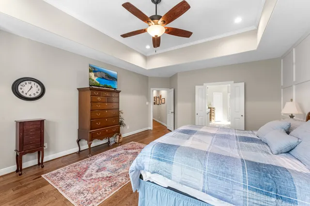 a bedroom with a bed and a chandelier