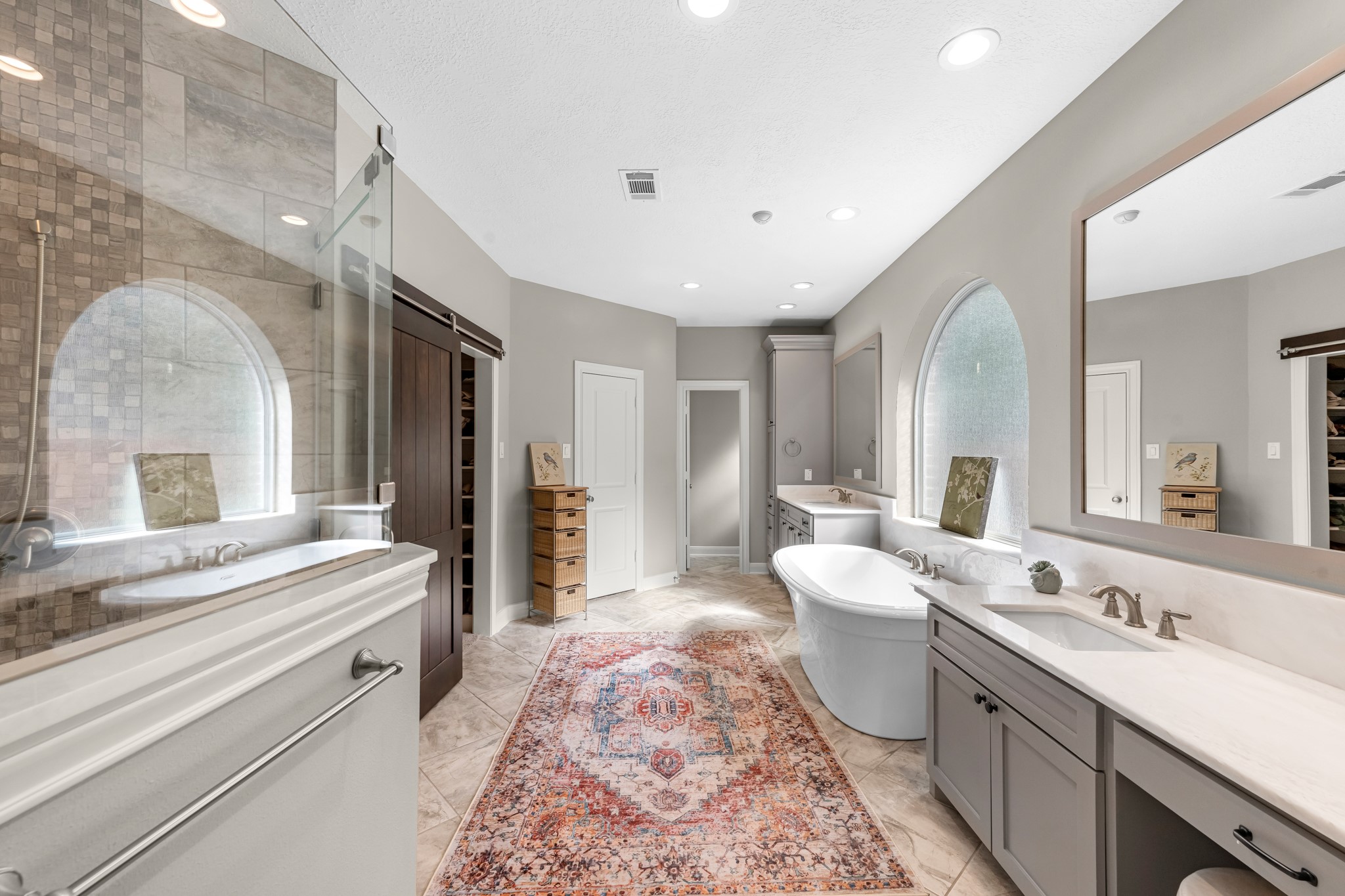 16207 Lafone Drive Spring, TX 77379 - Photo 31 of 49 a spacious bathroom with a double vanity sink a mirror and a bathtub