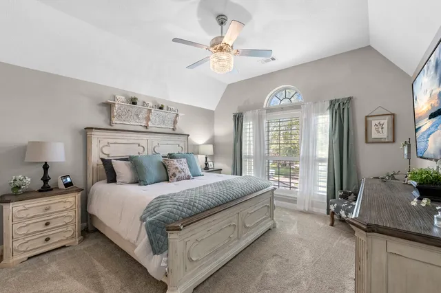 a bedroom with a bed and a chandelier