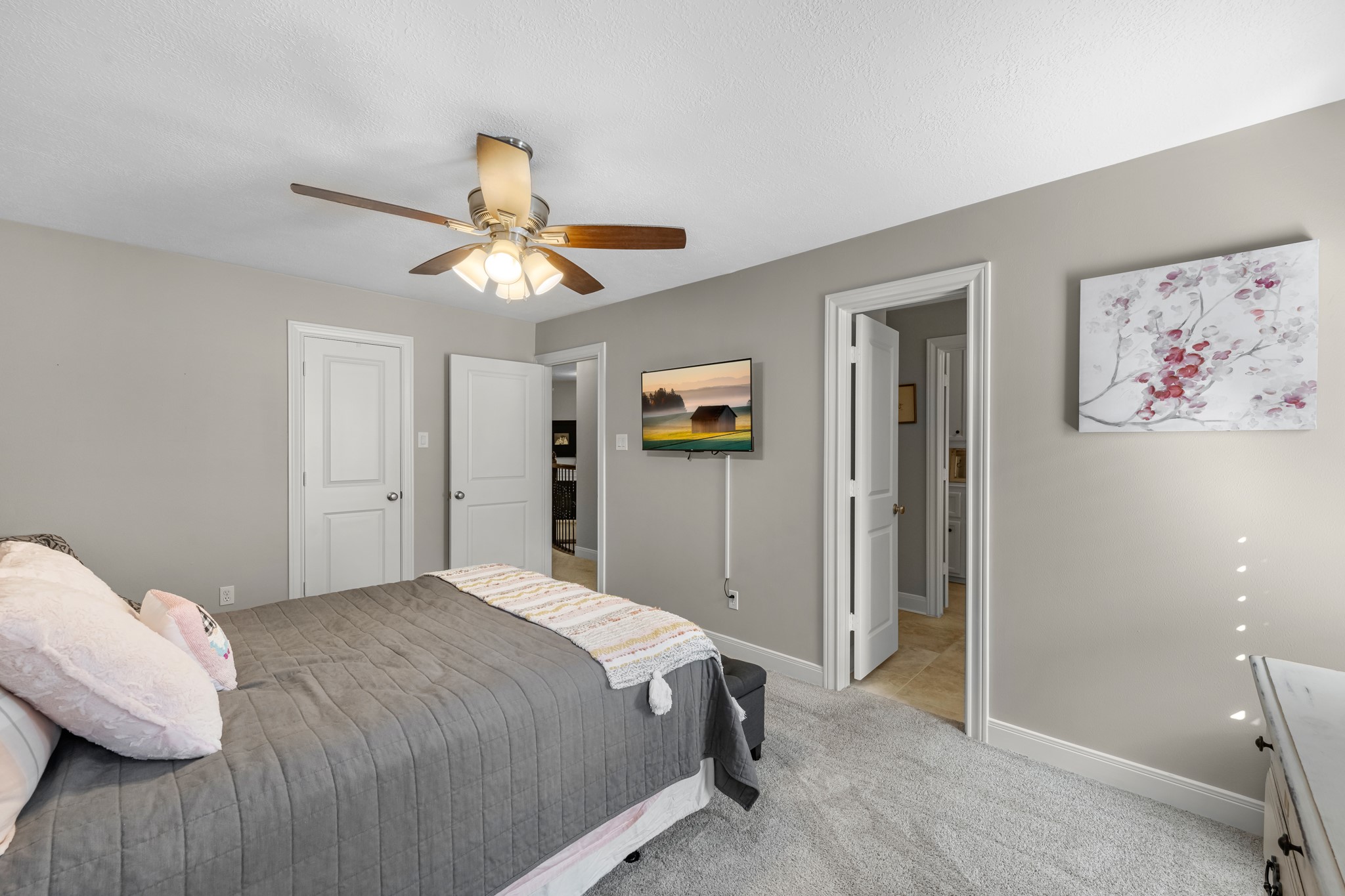 16207 Lafone Drive Spring, TX 77379 - Photo 39 of 49 a bedroom with a bed and a chandelier