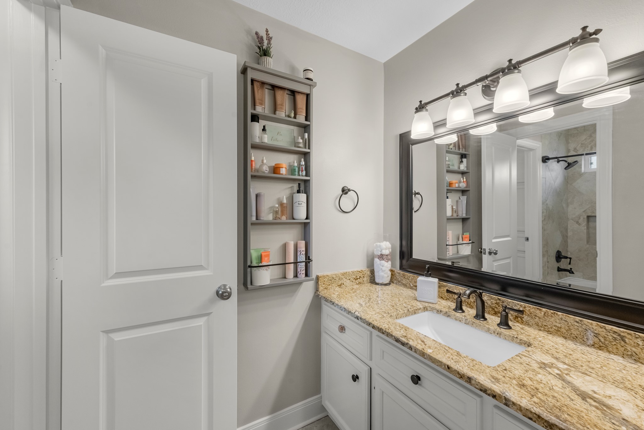 16207 Lafone Drive Spring, TX 77379 - Photo 44 of 49 a bathroom with a granite countertop sink and a mirror