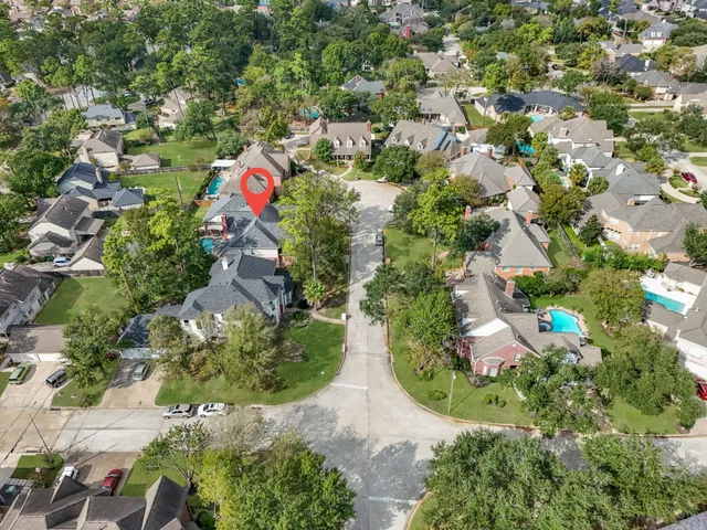 an aerial view of residential house with outdoor space and swimming pool