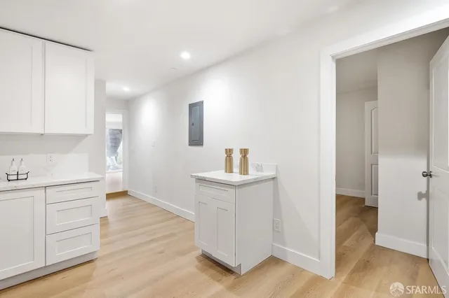 a kitchen with white cabinets and appliances