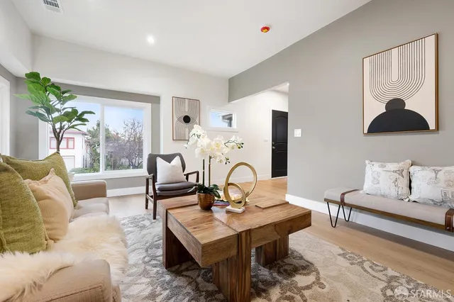 a living room with furniture and a potted plant