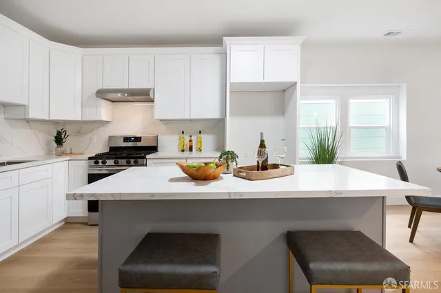 a kitchen with a sink cabinets and a window