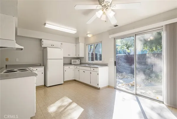 a stove top oven sitting inside of a kitchen