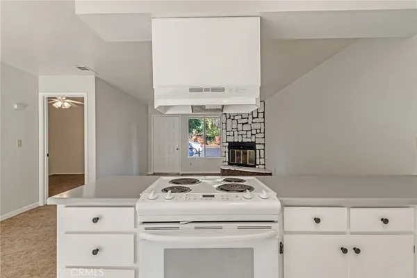 en empty room with fan and a ceiling fan