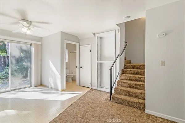 a kitchen with white cabinets and appliances