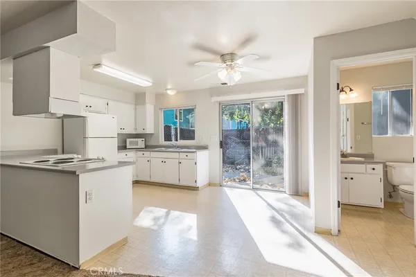 a kitchen with white cabinets and white appliances