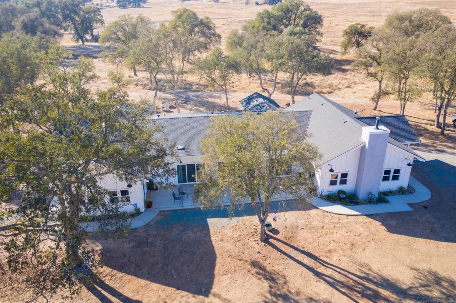 9090 Warren Road Valley Springs, CA 95252 - Photo 1 of 1 a view of a house with large trees