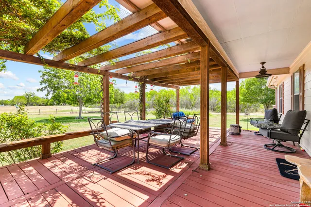 a living room with patio furniture and a floor to ceiling window