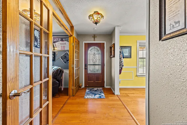 a dining room with furniture a fireplace and wooden floor