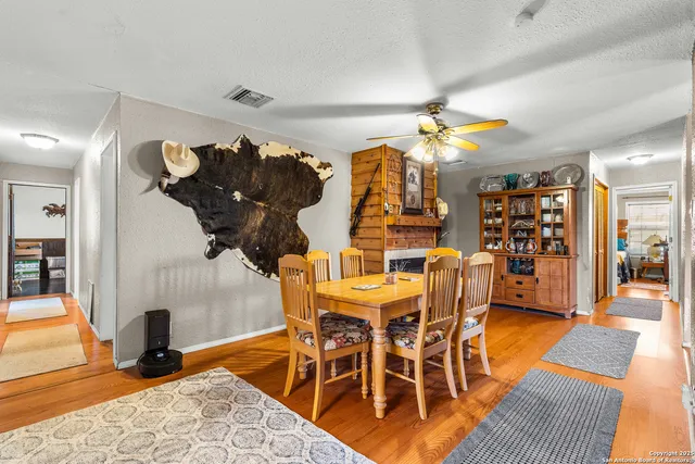 a living room with furniture a fireplace and a chandelier