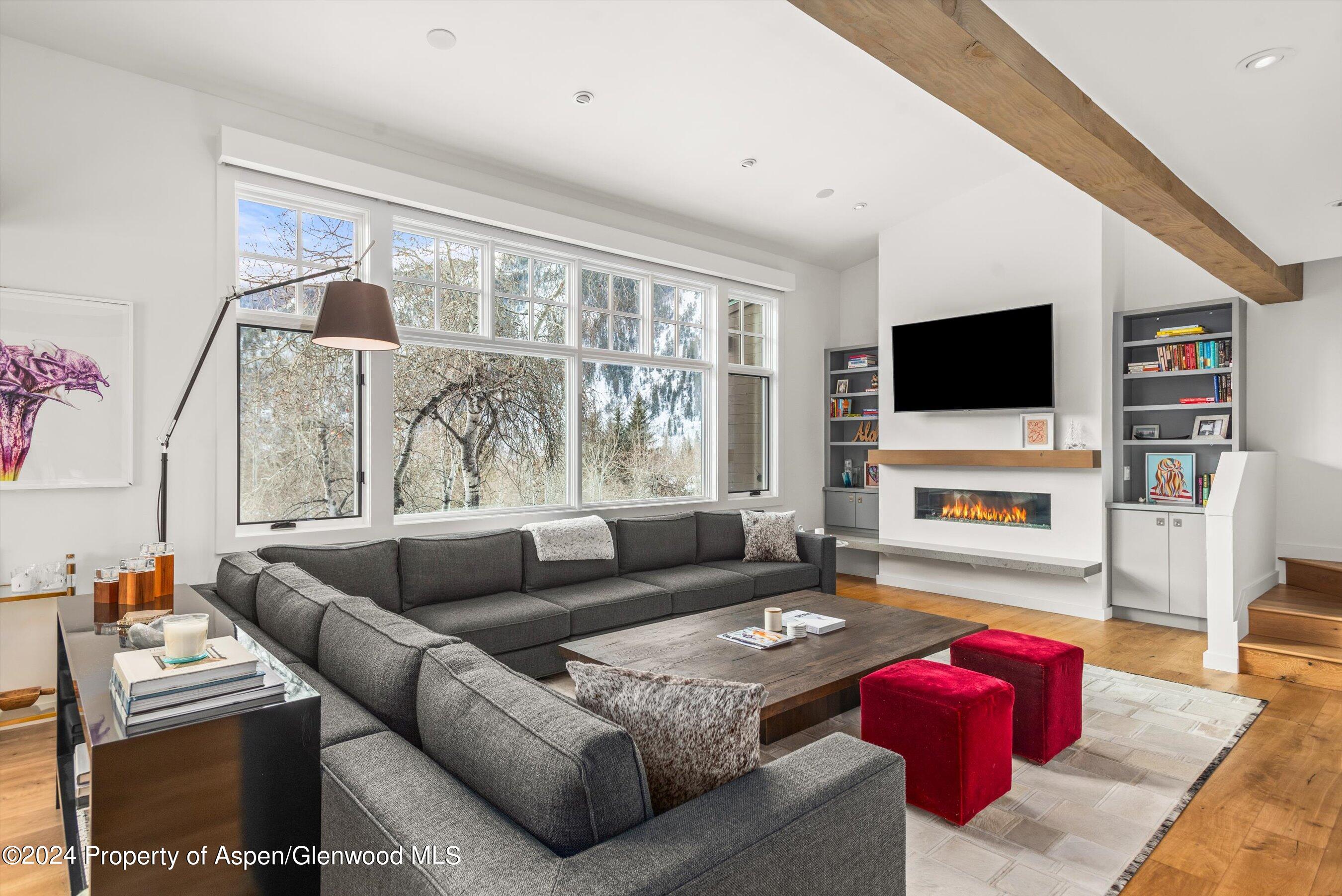 a living room with furniture a flat screen tv and a fireplace