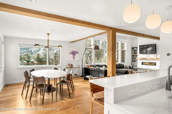 a view of a dining room with furniture wooden floor and chandelier