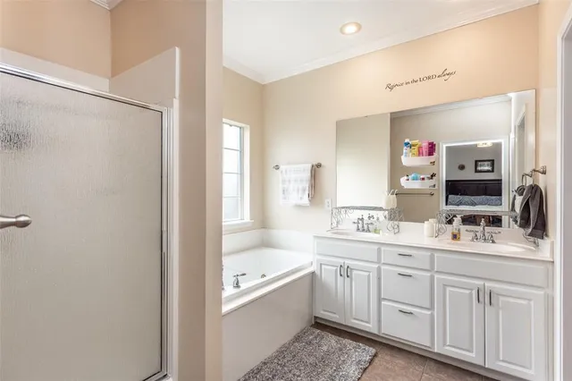 a bathroom with a double vanity sink mirror and bathtub