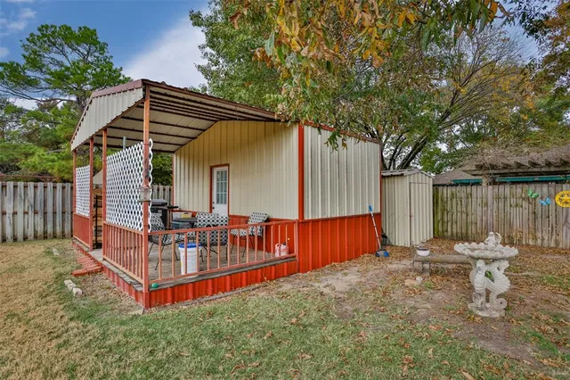 a view of backyard with swimming pool and wooden fence