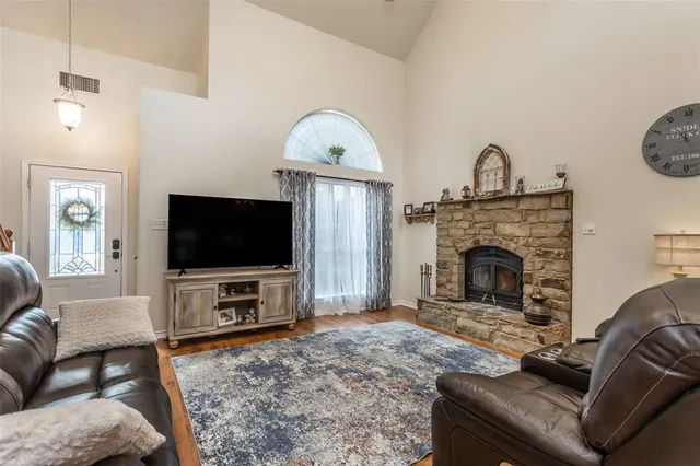 a living room with furniture a flat screen tv and a fireplace