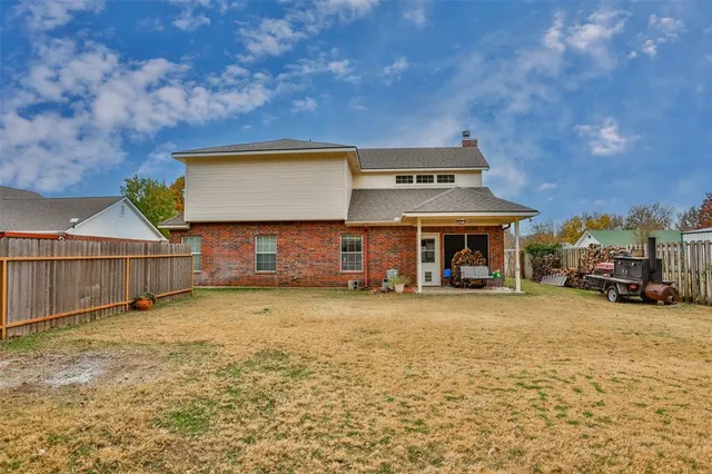 a view of a house with a yard and sitting area