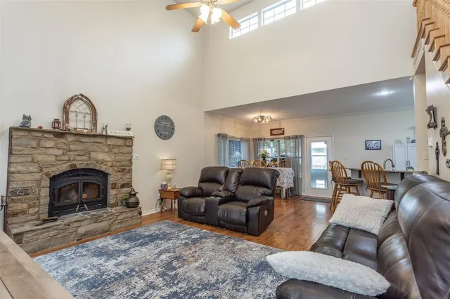 a living room with furniture a fireplace and a flat screen tv