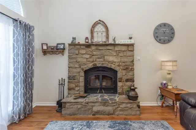 a living room with a fireplace furniture and a window
