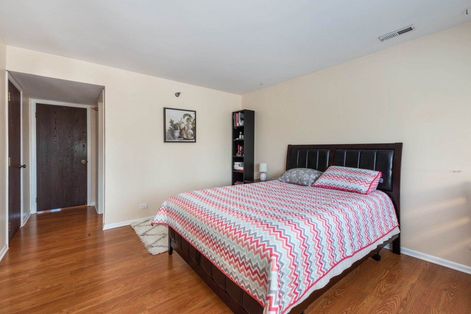 4180 Cove Lane, Unit C Glenview, IL 60025 - Photo 12 of 19 a bedroom with a bed and wooden floor